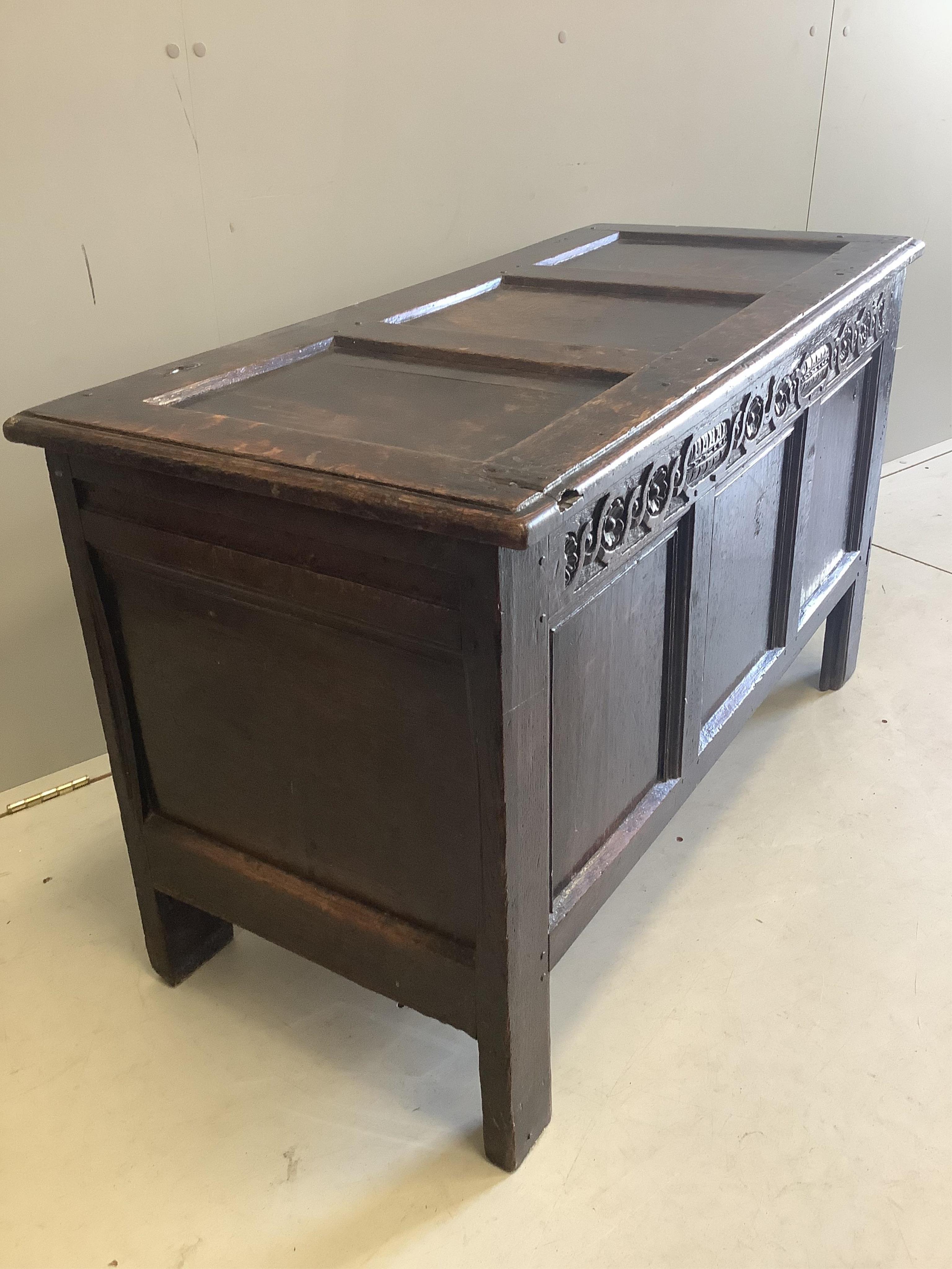 A late 17th century oak coffer three panel top, width 102cm, depth 50cm, height 165cm